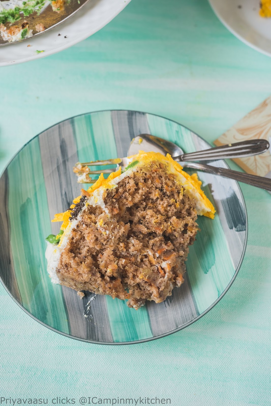 a slice of carrot pineapple cake on a plate with cutlery