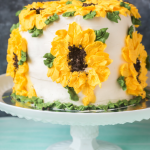 Carrot pineapple cake, decorated like sunflowers, on a cake stand