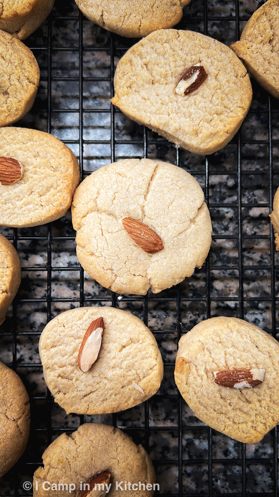 Close up shot of eggless crunchy almond cookies on a wire rack