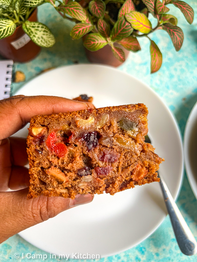 A beautiful slice of fruit cake with dried fruits and nuts studded.